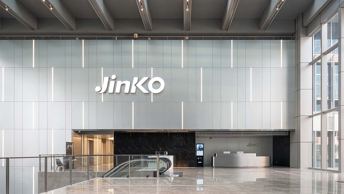 A Jinko logo on the wall of an international headquarters building
