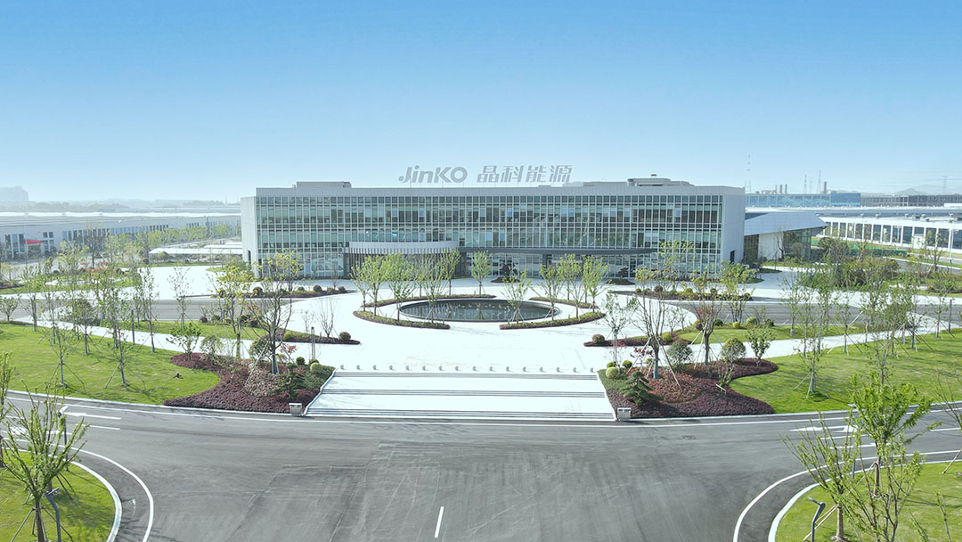 Jinko's international headquarters building in a sunny landscape